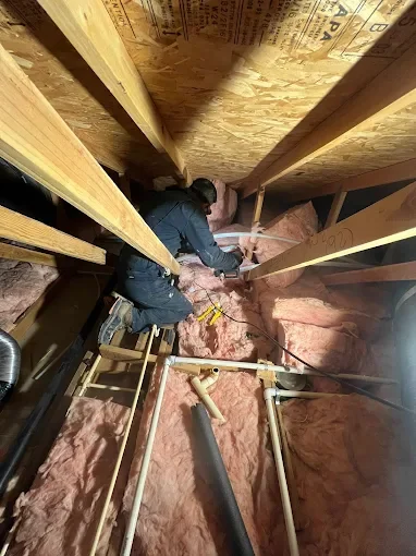 Bert's Mega Plumbing tech repairing a visible pipe leak in a San Fernando Valley home